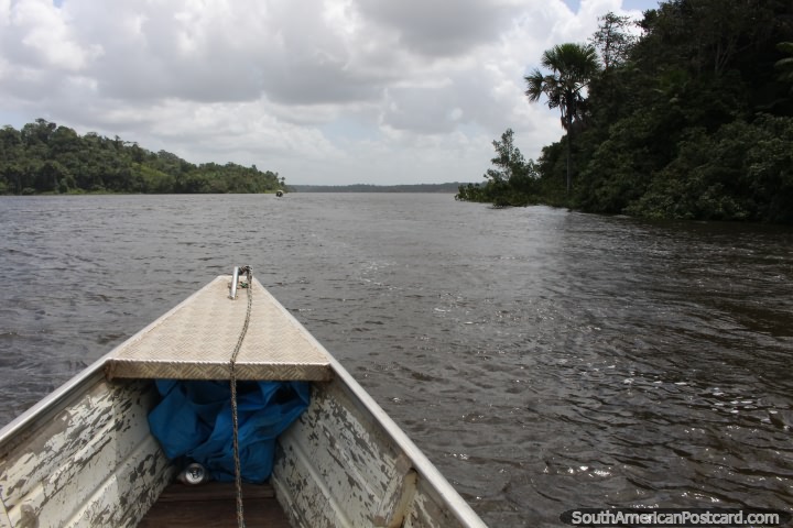 Traveling by small boat from Oiapoque to Saint Georges, The Brazil to French Guiana border cross. (720x480px). The 3 Guianas, South America.