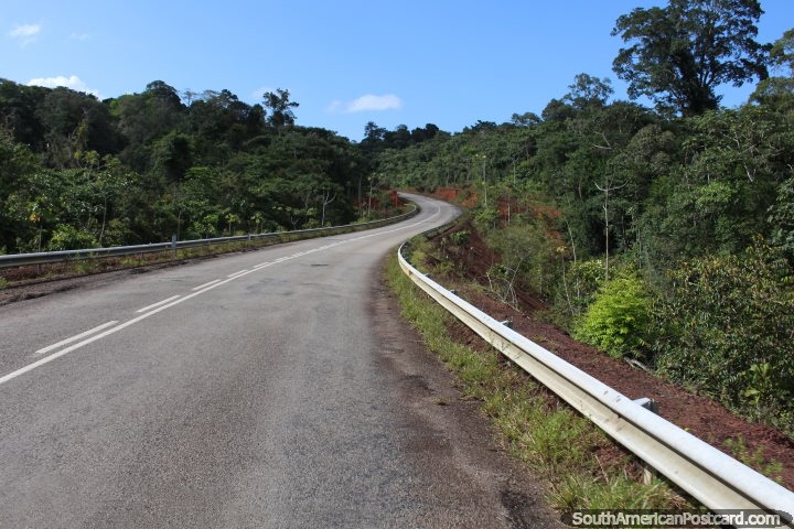 The road winds gently through the clean green countryside between Saint Georges and Cayenne, French Guiana. (720x480px). The 3 Guianas, South America.