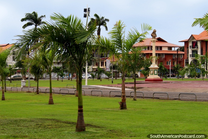 A tall monument and smaller palm trees beside the Place des Palmistes in Cayenne, French Guiana. (720x480px). The 3 Guianas, South America.