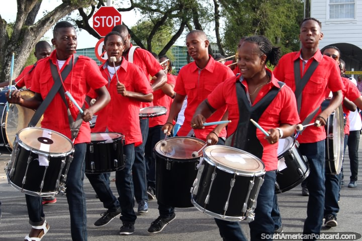 Drummers dressed in red and black from the group De Melkcentrale N.V. at the Avondvierdaagse parade in Paramaribo, Suriname. (720x480px). The 3 Guianas, South America.