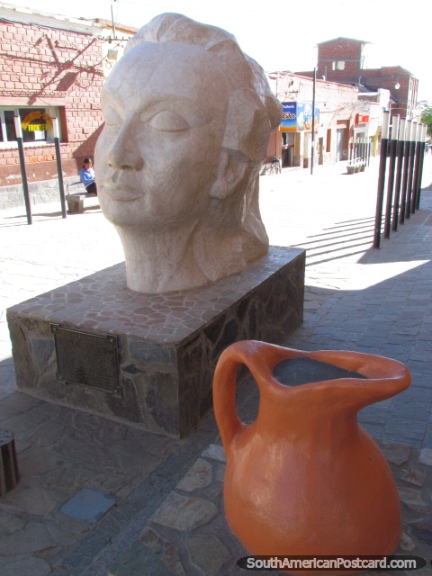 White head and orange jug sculptures in La Quiaca, Belgrano pedestrian walkway. (480x640px). Argentina, South America.