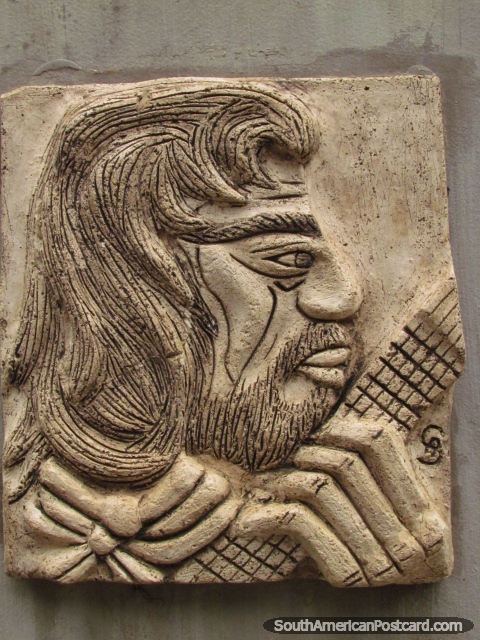Plaque of a bearded guitarist at Plaza Artigas in Colon. (480x640px). Argentina, South America.