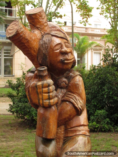 Wooden sculpture figure at Plaza San Martin in Colon. (480x640px). Argentina, South America.