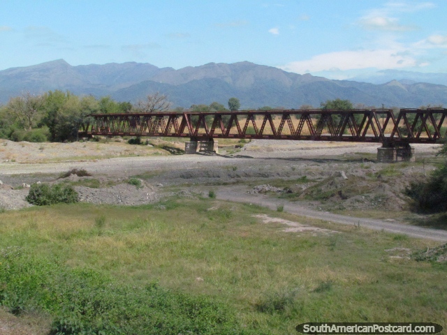 Train tracks run over the river just before passing through El Carril. (640x480px). Argentina, South America.