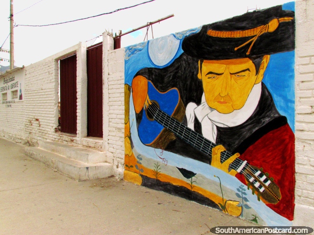 Guitarist plays his music, fantastic wall mural in Cafayate. (640x480px). Argentina, South America.