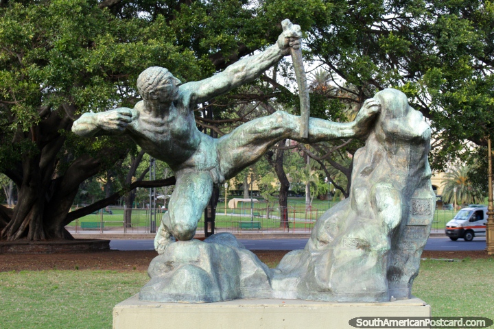Man with a primitive bow and arrow style weapon, a bronze work in a Buenos Aires park. (720x480px). Argentina, South America.
