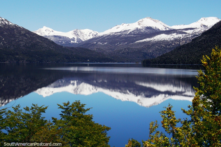 Reflexões de espelho em um lago ultraliso de montanhas nevosas entre Bariloche e El Bolson. (720x480px). Argentina, América do Sul.
