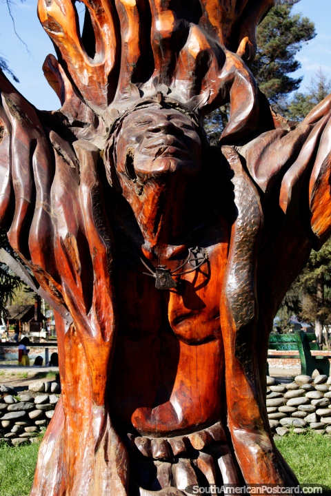 Indian Chief carved from the trunk of a tree in Plaza Pagano in El Bolson. (480x720px). Argentina, South America.