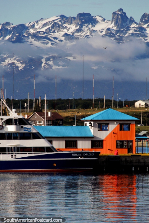 The Ushuaia Explorer boat docked at the port and beautiful mountains behind. (480x720px). Argentina, South America.