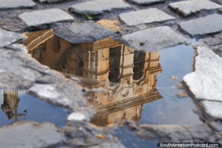Cordoba cathedral and statue, reflection in a puddle and cobblestones. (720x480px). Argentina, South America.