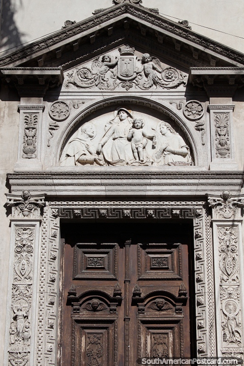 Amazing doorway in Santa Fe with engraved sculptures made of stone surrounding it. (480x720px). Argentina, South America.