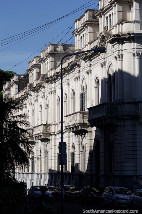 Grey stone balconies and arches of the government palace in Parana, side view. (480x720px). Argentina, South America.