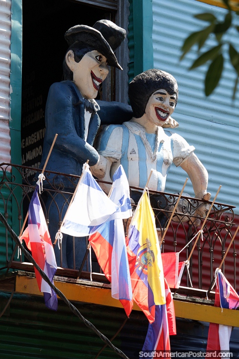 Diego Maradona and friend with big smiles watching the street from a balcony in La Boca, Buenos Aires. (480x720px). Argentina, South America.
