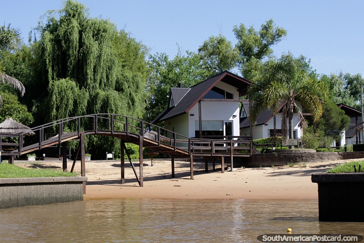 Private houses with a beach, bridge and nature behind, beside the river in Tigre, Buenos Aires. (720x480px). Argentina, South America.