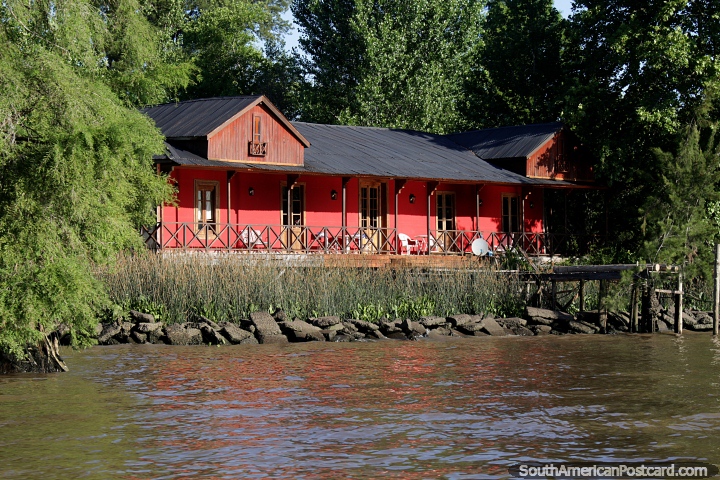 Long red house in the sunlight at days end beside the river delta in Tigre, Buenos Aires. (720x480px). Argentina, South America.