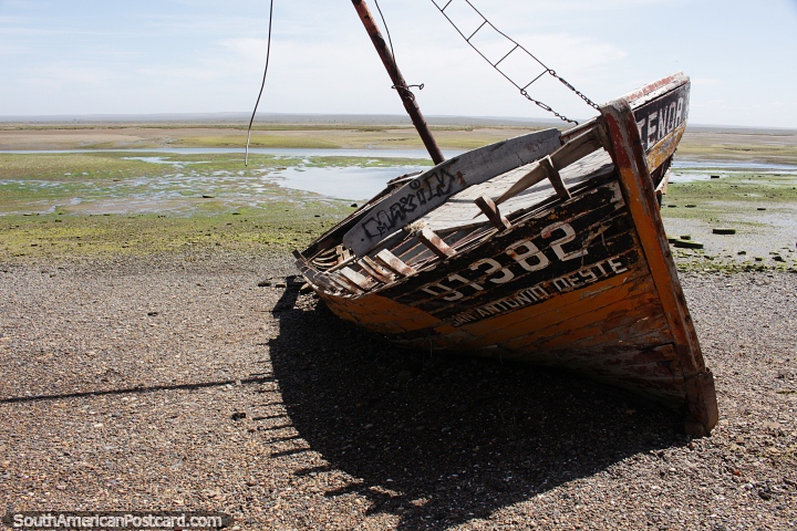 Wooden boat wreck and a watery wilderness at low tide in San Antonio Oeste. (720x480px). Argentina, South America.