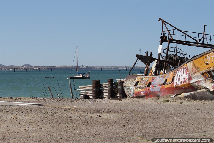 Boat wreck on the shore and a blue seas beyond in Comodoro Rivadavia. (720x480px). Argentina, South America.