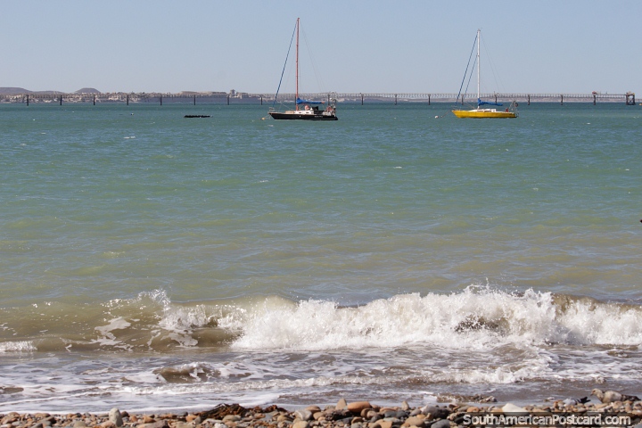 Pair of sailing boats, blue and yellow in the bay in Comodoro Rivadavia. (720x480px). Argentina, South America.