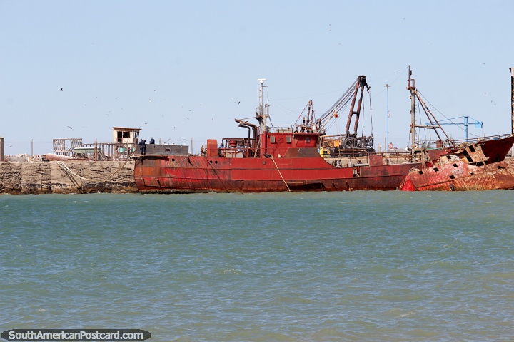 Big red ship and a shipwreck at the port in Comodoro Rivadavia. (720x480px). Argentina, South America.