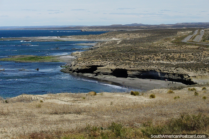 People on a remote beach and the coastal road between Comodoro Rivadavia and Caleta Olivia. (720x480px). Argentina, South America.