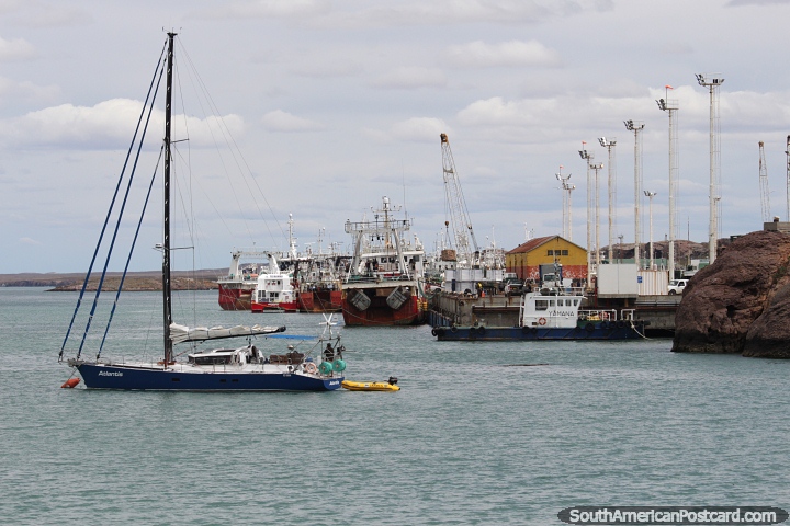 The port in Puerto Deseado with a sailing boat in the foreground. (720x480px). Argentina, South America.