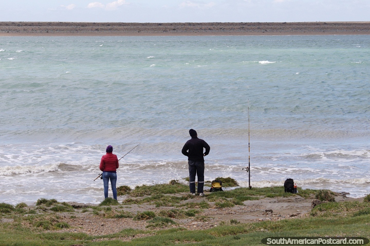 Man and woman fishing in the strong coastal waters in Puerto San Julian. (720x480px). Argentina, South America.