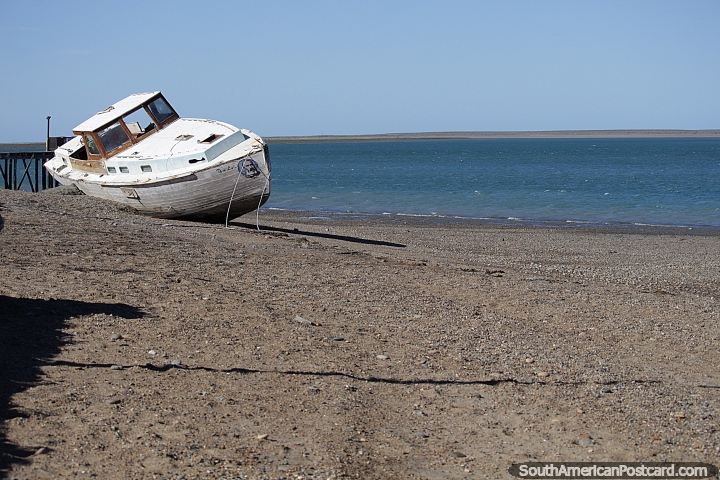 Boat hull on the beach in Puerto San Julian, blue seas. (720x480px). Argentina, South America.