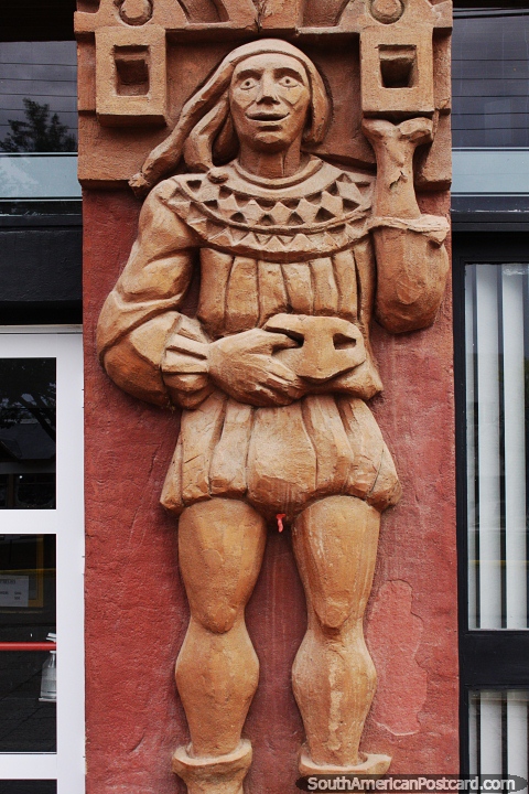 Man holds a mask, ceramic work, the facade of the theater in Piedrabuena. (480x720px). Argentina, South America.