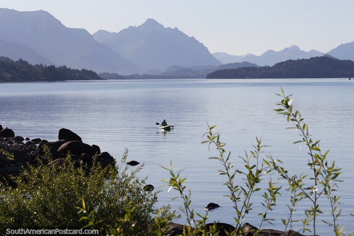 Girl paddles a kayak on Nahuel Huapi Lake in Bariloche, great scenery. (720x480px). Argentina, South America.