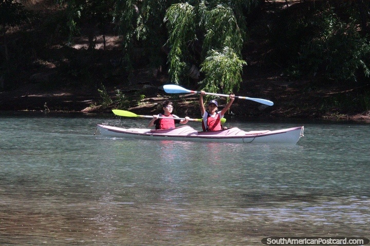 2 boys in a double-kayak enjoy their day on the river in Neuquen. (720x480px). Argentina, South America.