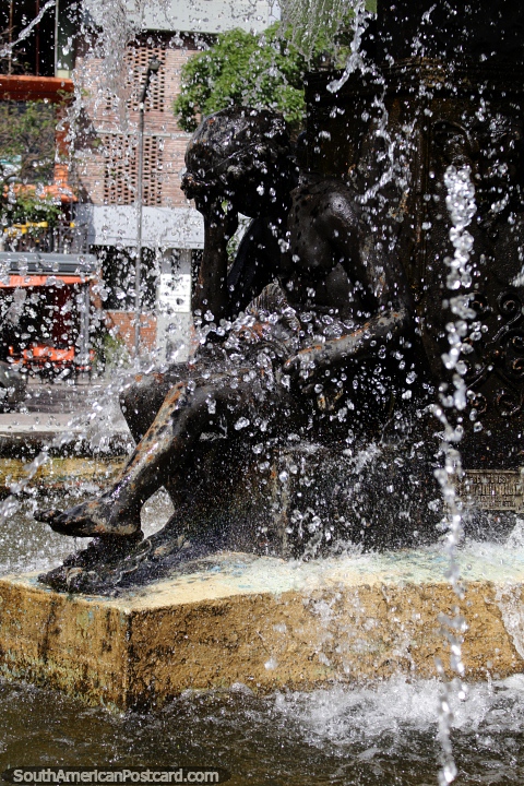 Bronze figure bathing in the fountain at the plaza in Santiago del Estero. (480x720px). Argentina, South America.