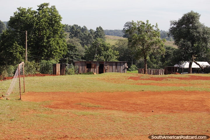 Basic wooden housing and a soccer pitch in the forest area in northern Misiones, south of Pozo Azul. (720x480px). Argentina, South America.