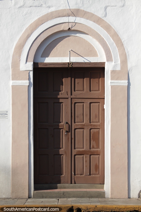 Wooden doorway with ceramic decoration around it in Santa Cruz. (480x720px). Bolivia, South America.