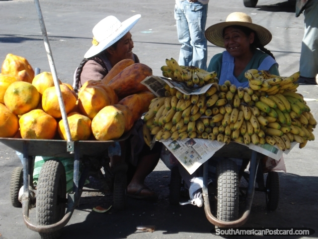 Melons and bananas in wheelbarrows being sold by 2 ladies in Cochabamba. (640x480px). Bolivia, South America.