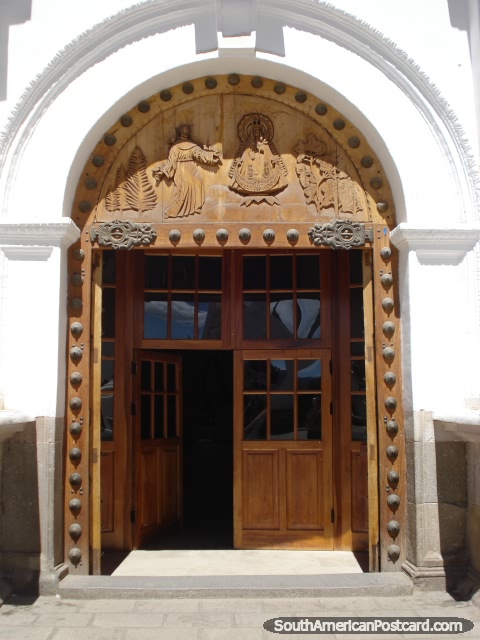 Copacabana cathedral front doorway with wooden carvings. (480x640px). Bolivia, South America.