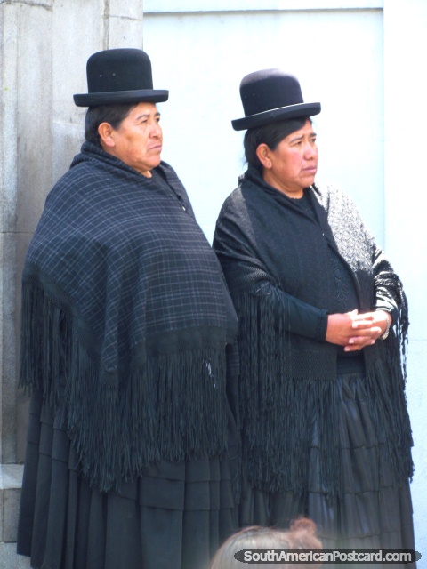 Two Bolivian woman dressed in black shawls and black hats, La Paz. (480x640px). Bolivia, South America.