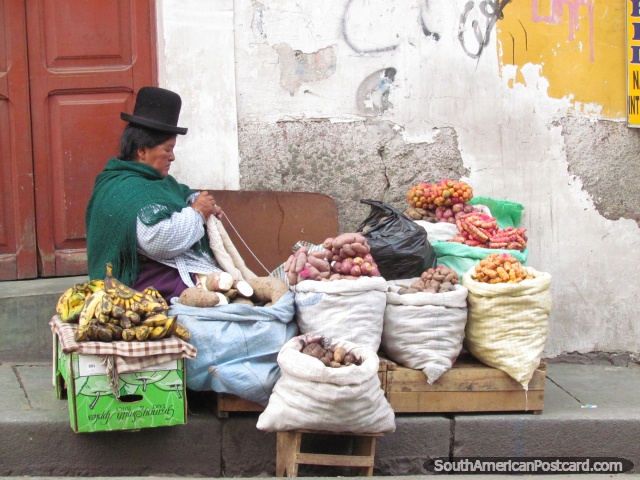 Woman knits and sells potatoes at La Paz markets. (640x480px). Bolivia, South America.