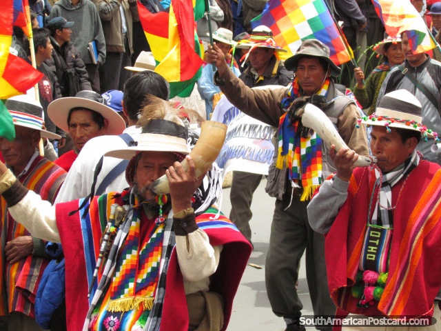 Indigenous men blow horns in marches of La Paz. (640x480px). Bolivia, South America.
