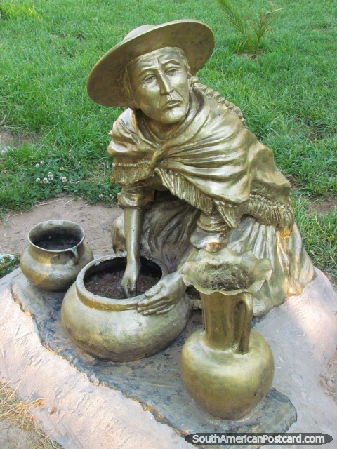 Gold monument of indigenous woman with pots in a Villazon park. (480x640px). Bolivia, South America.
