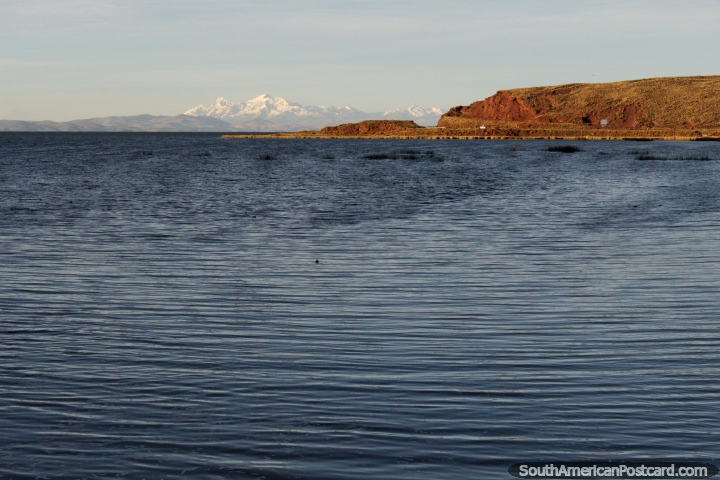 Lake Titicaca with snow-capped mountain in the distance, view from Desaguadero. (720x480px). Bolivia, South America.
