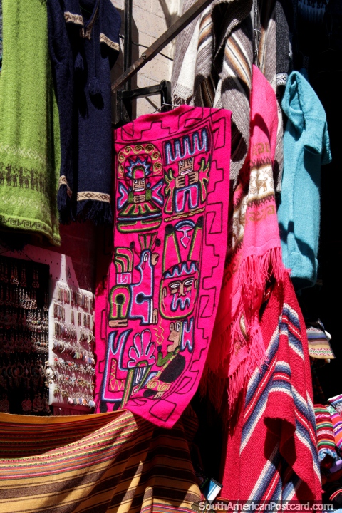 Bright pink clothing with indigenous designs for sale in La Paz. (480x720px). Bolivia, South America.