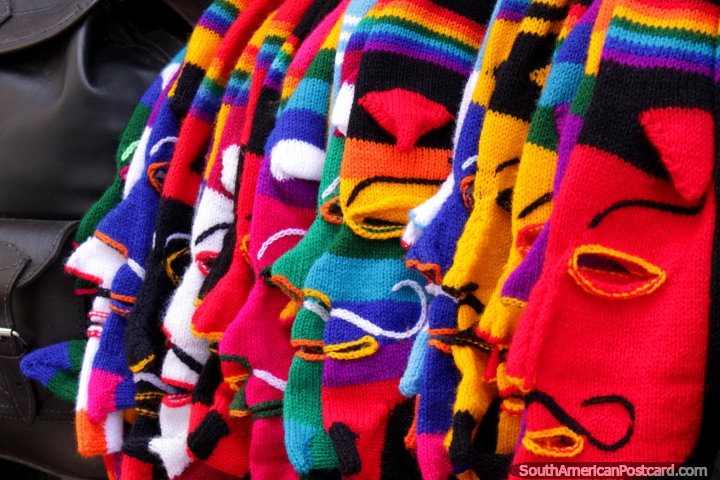 A row of full head balaclavas in a rainbow of colors in La Paz. (720x480px). Bolivia, South America.