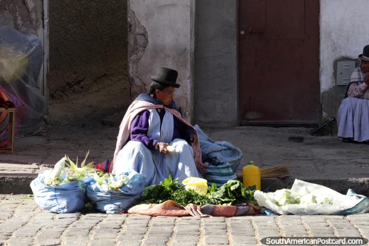 This woman has corn and spinach to sell at the food markets in La Paz - Mercado Rodriguez. (720x480px). Bolivia, South America.