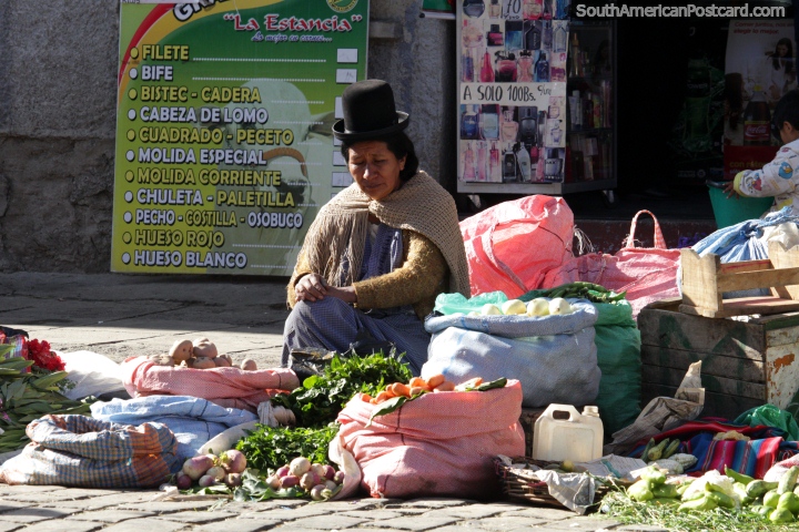 This woman is selling turnips, carrots, potatoes and greens at the La Paz food markets. (720x480px). Bolivia, South America.