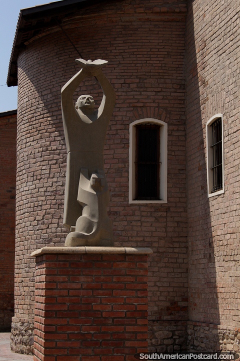 Stone artwork, figure releases a bird, at Church San Francisco in Tarija. (480x720px). Bolivia, South America.