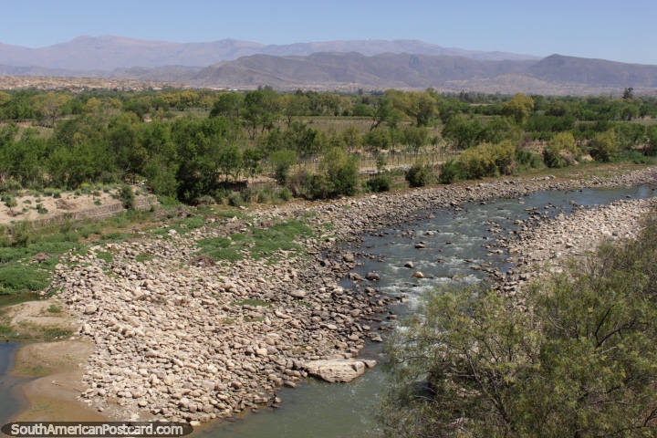 A rocky river and distant mountains, sights seen during the wine tour in Tarija. (720x480px). Bolivia, South America.
