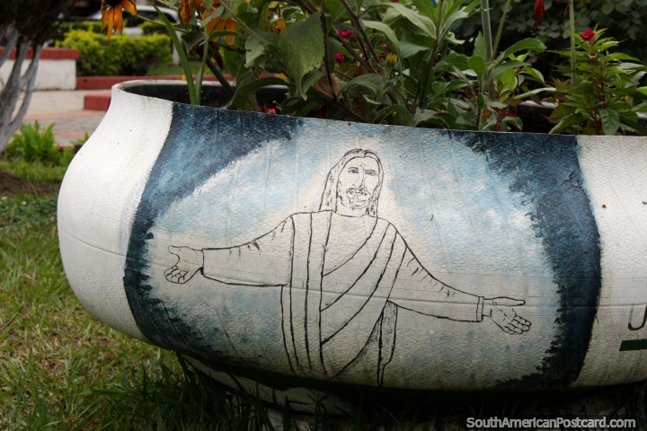 Jesus with outstretched arms, painted on to a plant pot in the plaza in Bermejo. (720x480px). Bolivia, South America.
