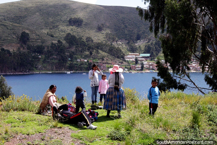 A family enjoys the views of the Strait of Tiquina between Copacabana and La Paz. (720x480px). Bolivia, South America.