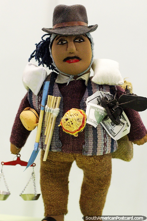 The man carries varies items and is known as El Ekeko, a tradition of Bolivia, Musef museum, Sucre. (480x720px). Bolivia, South America.