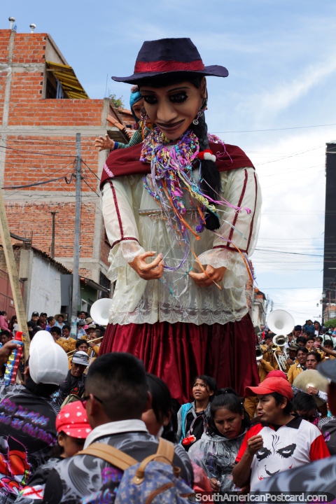 Huge boneco gets carried through the crowd at the Sucre carnival. (480x720px). Bolivia, South America.